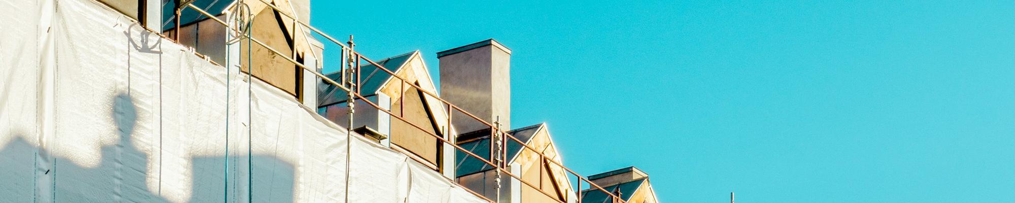 Photo of a few rooftops and blue sky
