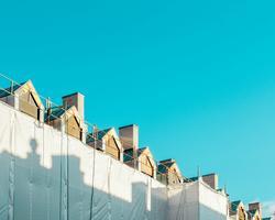 Photo of a few rooftops and blue sky