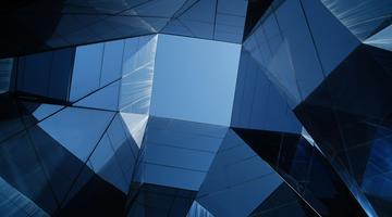 A building with curved glass and view to the sky